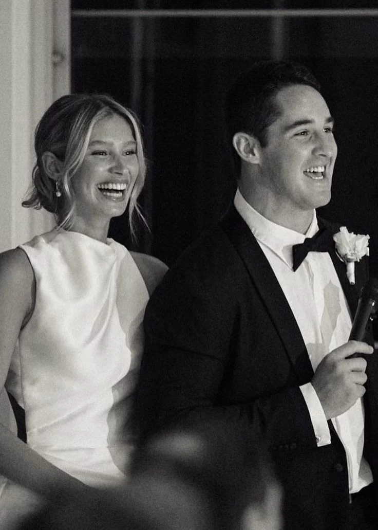 Couple laughing together during classic mr and mrs game at reception